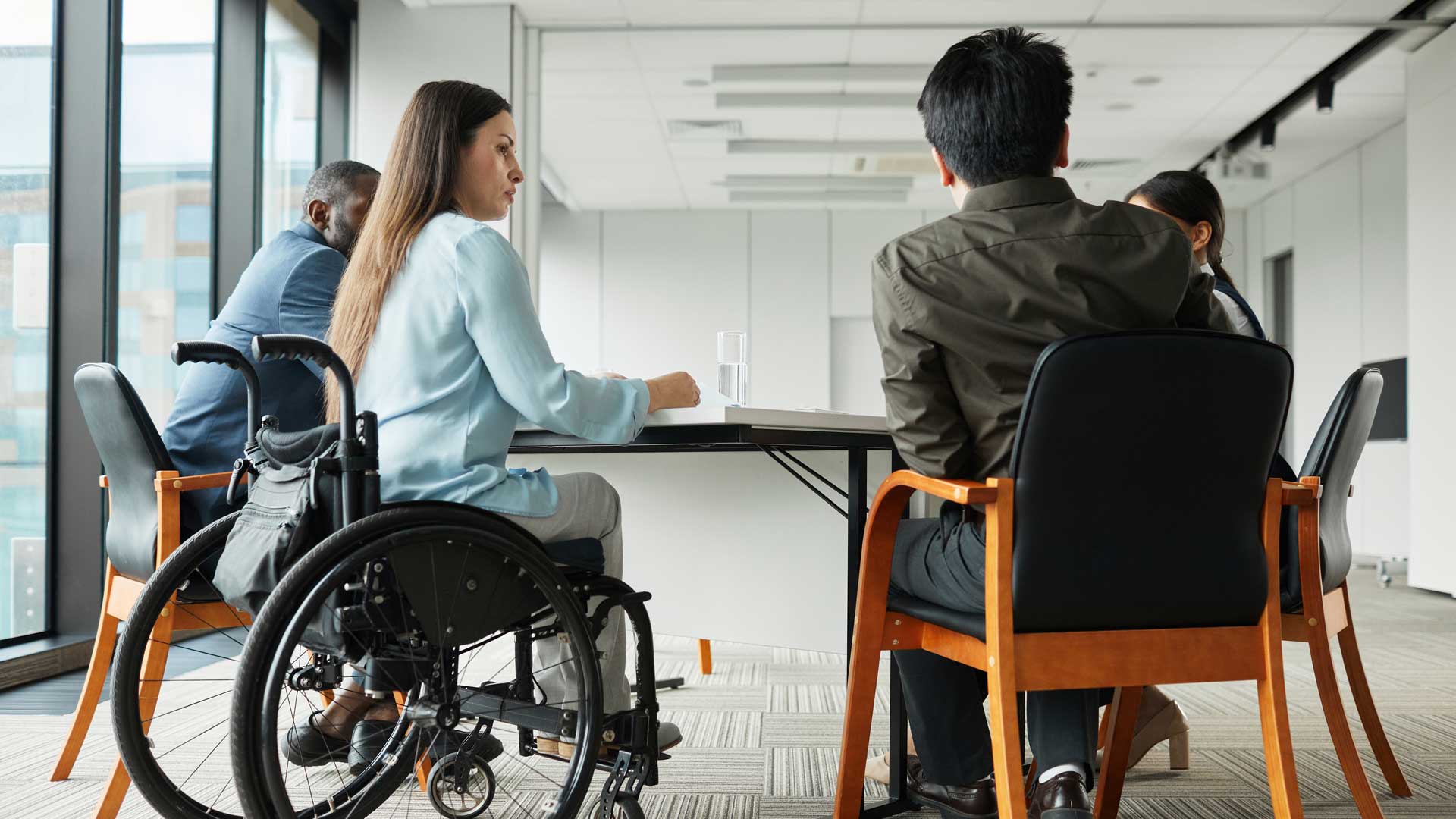 Disabled person discussing accessibility in her workplace